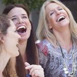 three women laughing and smiling