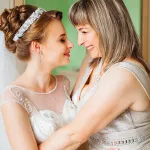 Mother of bride embracing bride