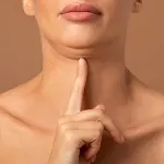 woman pointing to double chin which can be treated with aqualyx